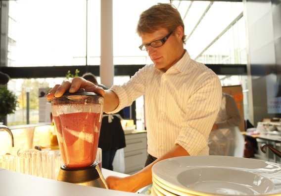 A Scrum team member mixes with fun the colorful smoothies