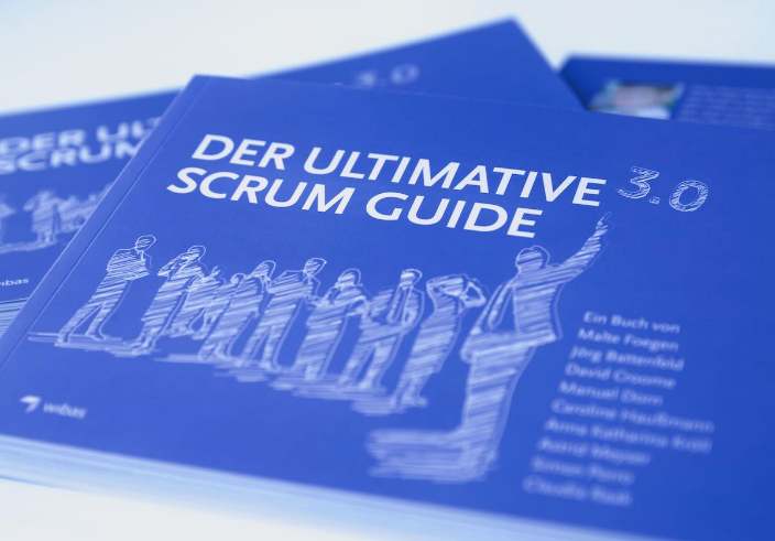 Image with several books Ultimate Scrum Guide 3.0