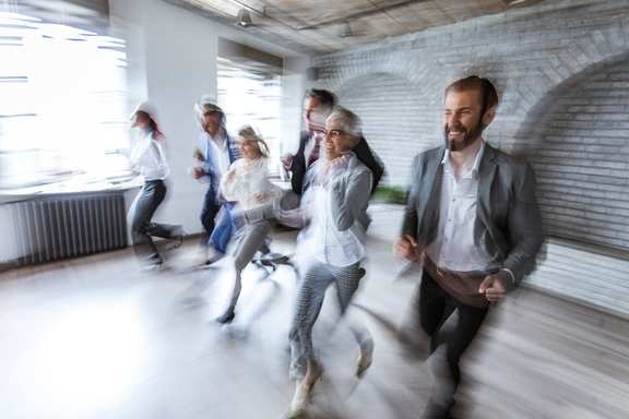 People in an office running