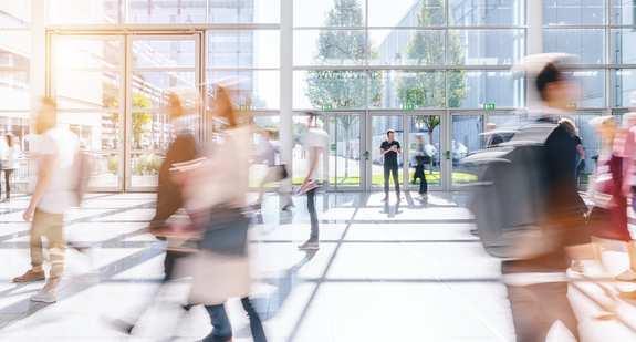 A large office hall - the entrance - where many people are on the move