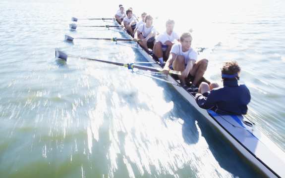 Team rowing together in time - slightly blurred